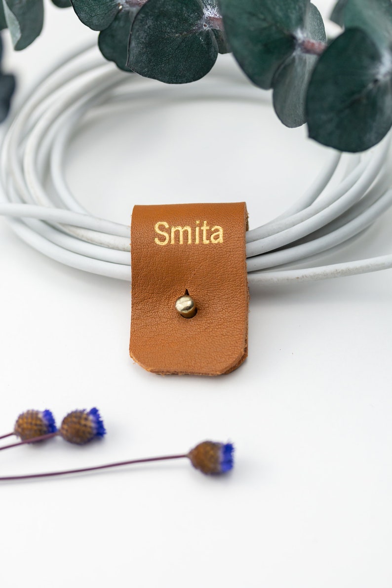 Closeup of Small Cord Holder with Gold lettering.