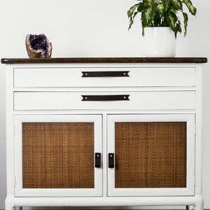 Leather Pulls installed on a white dresser on the bottom doors.