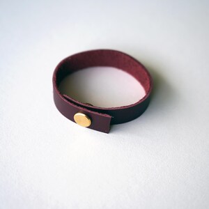 Deep burgundy Wine leather loop crafted from full-grain leather, paired with brass hardware for a warm modern contrast.