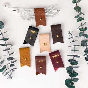 Small Leather Cord Holders displayed on a white background displaying available colors.