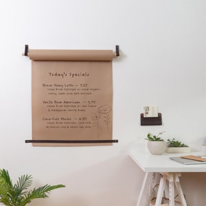 A Kraft Paper Holder installed on the wall next to a desk.