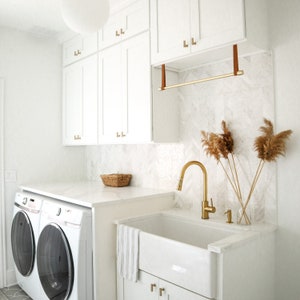 A laundry room with a hanging rack for drying laundry.