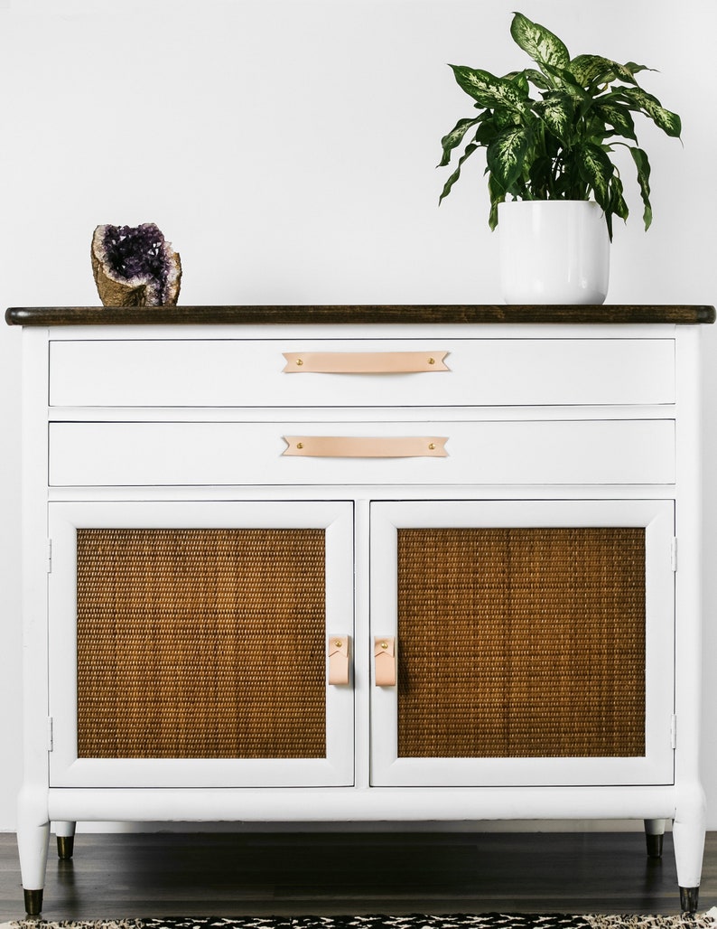 Leather Pulls installed on a white dresser on the bottom doors.