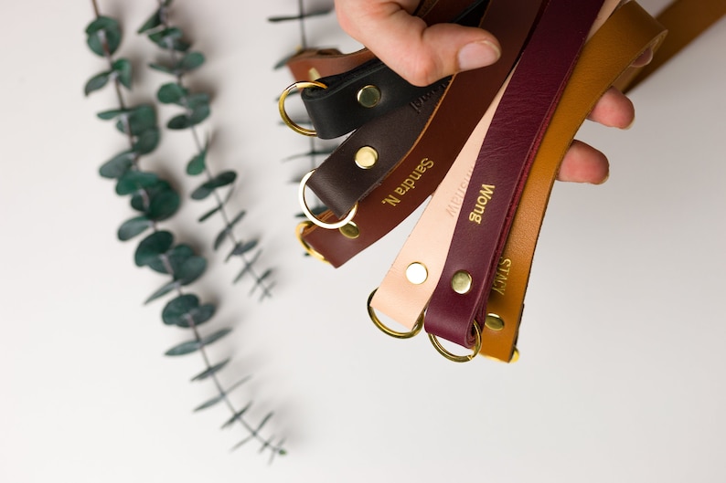 Thick lanyards held in a hand showing available colors.