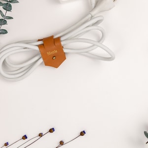 Leather Cable Holder displayed on a white background showing wrapping a cord.