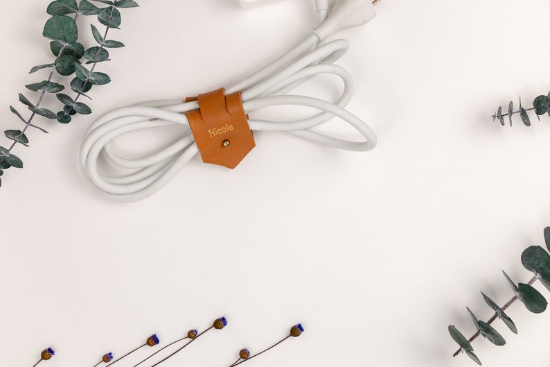 Leather Cable Holder displayed on a white background showing wrapping a cord.