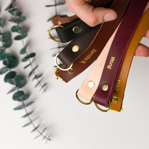 Thick lanyards held in a hand showing available colors.