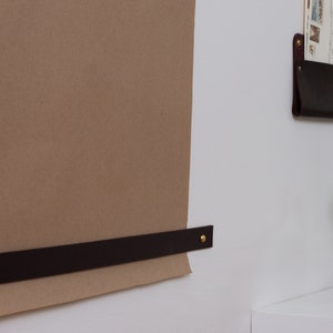 Keyaiira Paper Securing Strap which holds the paper down against the wall.