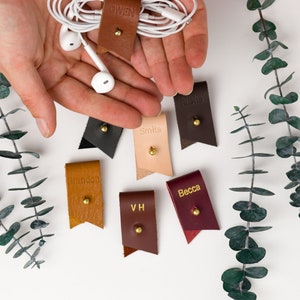 Small Leather Cord Holders displayed on a white background displaying available colors.