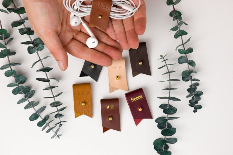 Small Leather Cord Holders displayed on a white background displaying available colors.