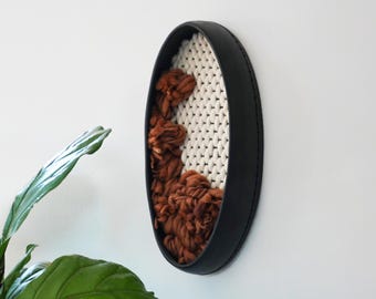 Black Ceramic Clay Frame with interior woven wall hanging in contrasting white and rust brown wool by keyaiira