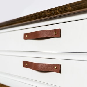 Leather Handles installed on a white dresser.