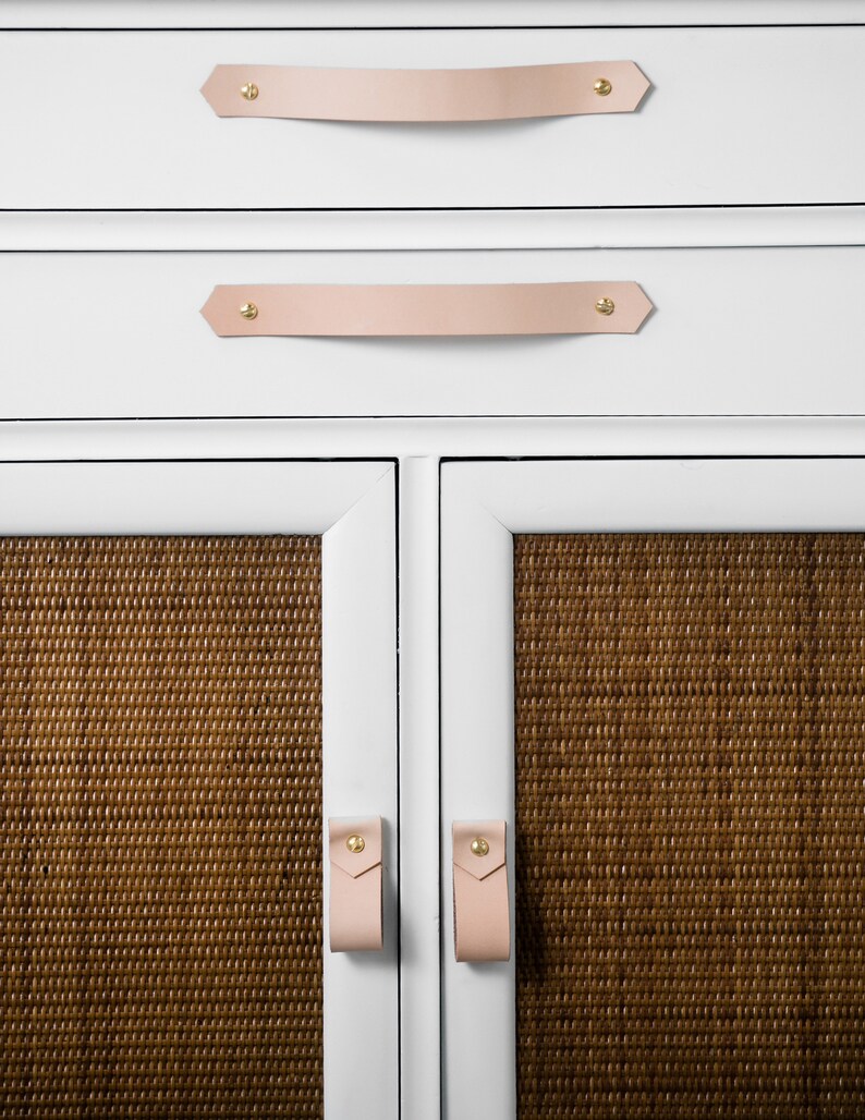 Leather Pulls installed on a white dresser on the bottom doors.