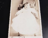 Vintage Victorian photograph of a little baby girl in a long white dress