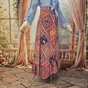 May include: A long, high-waisted skirt featuring a vibrant, multi-colored diamond-patterned print in shades of red, blue, yellow, and white, paired with a light blue long-sleeved button-down shirt with a tie-front detail at the waist.