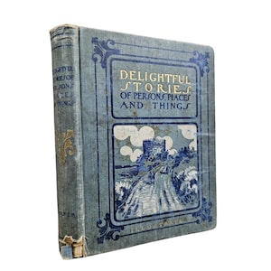 May include: A vintage hardcover book titled Delightful Stories of Persons, Places and Things. The cover is light blue with dark blue decorative borders and a central illustration of a stone castle on a hill. Gold lettering is visible on the front.