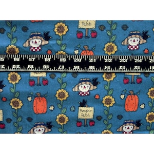 May include: Teal fabric with a repeating pattern of sunflowers, scarecrows, pumpkins, and apples. The scarecrows wear hats and have red and white checkered bibs. The text "Pumpkin Patch" and "Patch" are on signs.