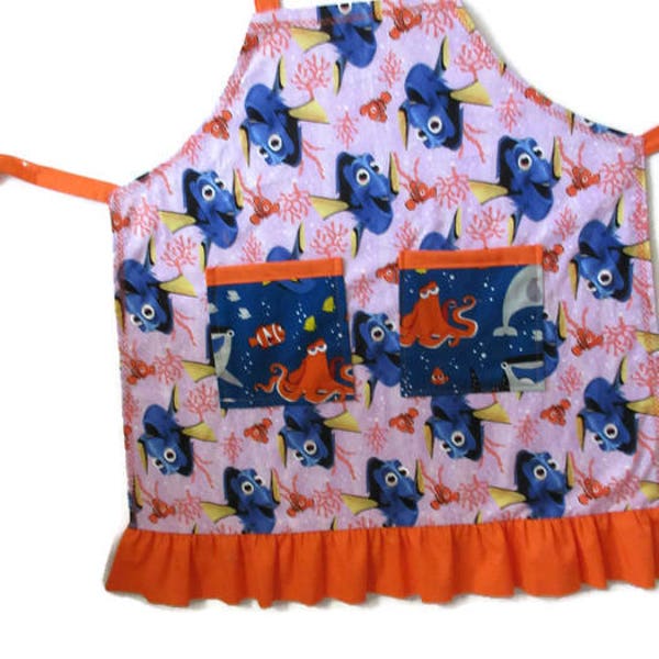 Medium Childs Girls Apron in Finding Dory & Nemo print in lilac, orange, and blue cotton fabrics