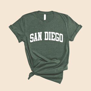 May include: A green t-shirt with the text "SAN DIEGO" in white letters.