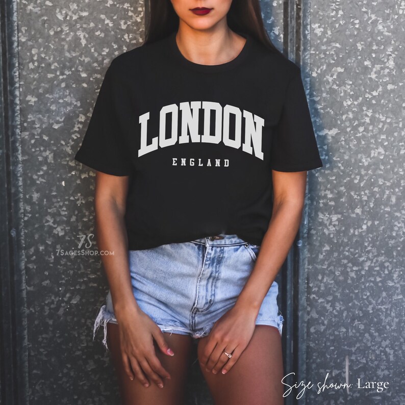 May include: Black t-shirt with white text that reads "LONDON ENGLAND" in a collegiate font.