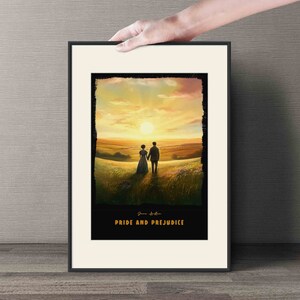 May include: A framed print of a couple walking hand-in-hand in a field with a sunset in the background. The print has the text "Jane Austen Pride and Prejudice" at the bottom.