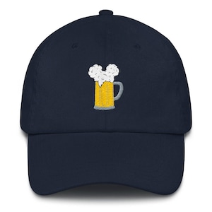 May include: A navy blue baseball cap with an embroidered image of a beer stein with a foamy head.