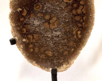 Polished agate geode, on a metal base, beautiful image formation
