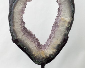 Polished XL amethyst ring on a metal stand, unique and rare.