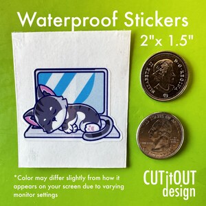 May include: Waterproof sticker of a cartoon cat sleeping on a laptop. The sticker is 2 inches by 1.5 inches.