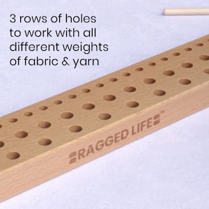 Close up image of wooden 50cm British peg loom with three rows of holes to weave with different thicknesses of fabric and woollen yarn.