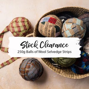 May include: A woven basket filled with several balls of wool selvedge strips. The balls are made from various patterned fabrics in shades of brown, green, blue, and red. The text "Stock Clearance" and "250g Balls of Wool Selvedge Strips" are displayed.