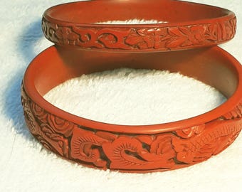 Two cinnabar Chinese red bangles - vintage carved dragon