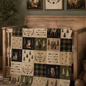 May include: A patchwork quilt featuring a woodland theme with alternating squares of dark green buffalo plaid, forest scenes with a fox, bear, owl, rabbit, and deer, and cream-colored panels with the text "YOU ARE SO DEERLY LOVED" and arrows.