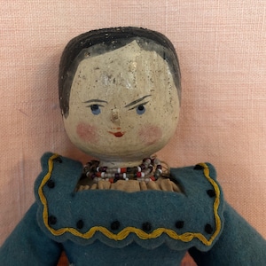 Lula, an antique wooden doll in period clothing