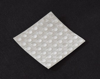 Coaster feet, transparent plastic, self adhesive, non slip, non scratch. Also called bumper feet. 8mm / 5/16" diameter. Pack of 49..