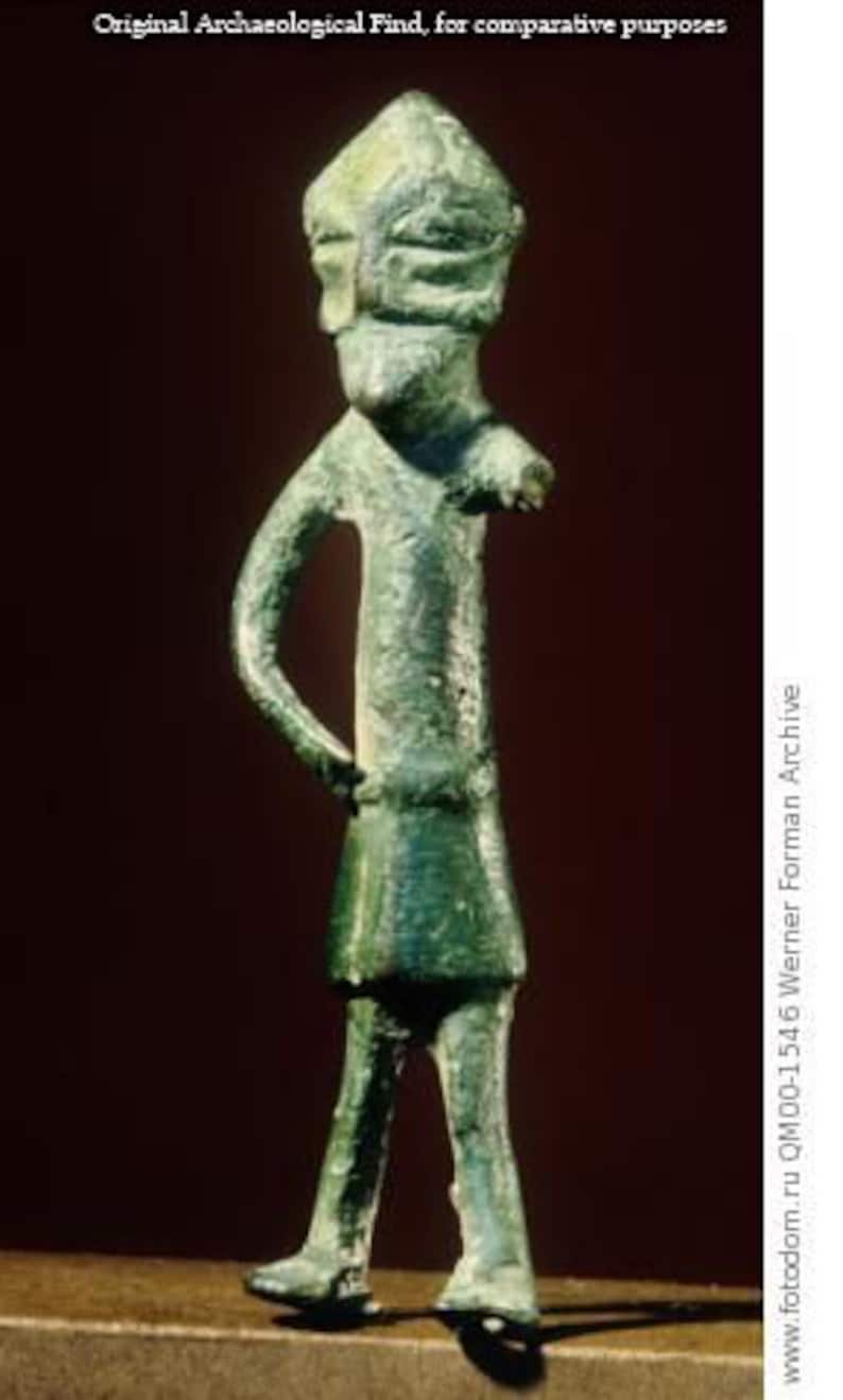May include: A green bronze figurine of a person wearing a pointed hat. The figurine is standing with its arms at its sides and its legs slightly apart.