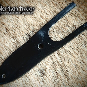 May include: Black metal knife blade with a U-shaped cutout. The blade is sharp and pointed. It is a historical reenactment item.