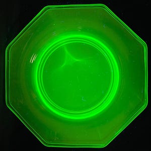 May include: A bright green octagonal glass plate with a raised rim and a smaller, circular, raised centre.