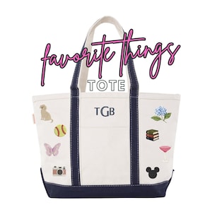 May include: A white canvas tote bag with navy blue trim and handles. The text "favorite Things TOTE" appears above the bag. The bag features the embroidered initials "TGB" and various patches including a dog, softball, butterfly, camera, hydrangea, books, cocktail glass, and mouse ears.