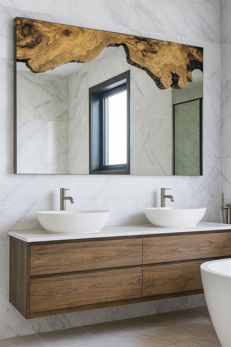 May include: Large rectangular mirror with a live edge wooden top. The mirror hangs above a floating vanity with two white vessel sinks and a wooden cabinet with four drawers. The bathroom has marble tile.