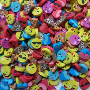 May include: A colorful assortment of emoji-shaped erasers in various designs. The erasers feature yellow, pink, blue, red, and brown colors, with different facial expressions, hearts, and sunglasses. These small erasers are ideal for school or office use.