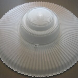 May include: White frosted glass lampshade with a fluted design. The shade has a smaller, inner shade with a similar fluted design.