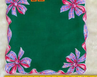 May include: Green square handkerchief with pink and purple plaid bows in each corner and along the edges. The edges are scalloped. The text "Now a New Choice" is visible.