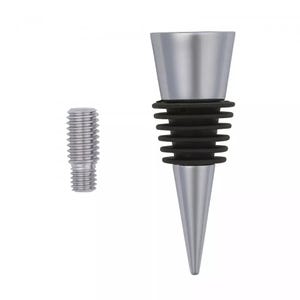 May include: A silver-colored metal bottle stopper featuring a tapered top, a series of black rubber rings for sealing, and a pointed base. Beside it sits a small, separate silver-colored metal threaded screw component for assembly.