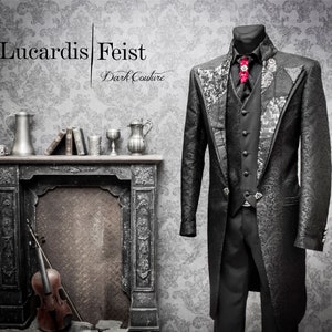 May include: A black formal suit with a patterned design, a black vest, and a black bow tie with a red flower accent. The suit is displayed on a mannequin in front of a fireplace with a violin and books on the mantle. The text "Lucardis Feist Dark Couture" is displayed above the mannequin.