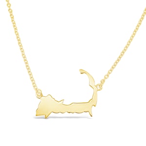 May include: A gold necklace with a pendant shaped like the outline of Cape Cod.