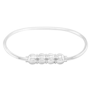 May include: A silver bangle bracelet with a series of four round beads in the center.