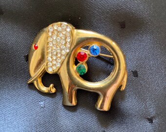 Vintage French elephant pin with red, blue and green stones, tiny rhinestones on ear.  Cute!