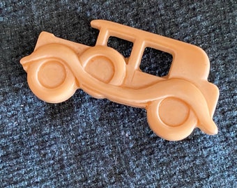 Vintage beige plastic car pin (1920’s car) probably made in 2950’s