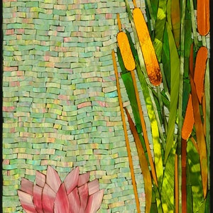 May include: A mosaic artwork depicting a frog sitting on a lily pad with roots and seed pods. The background features tall green reeds with yellow cattail flowers and white dragonfly wings.